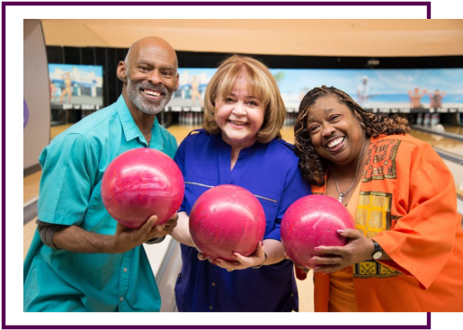 People holding bowling balls